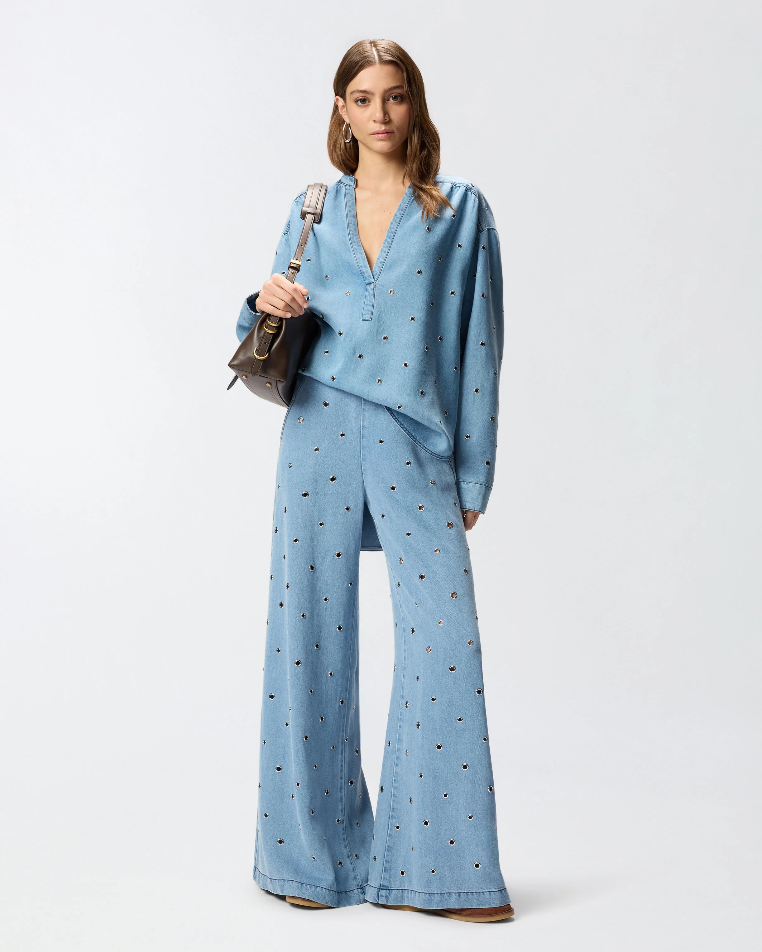 Denim jeans with eyelets